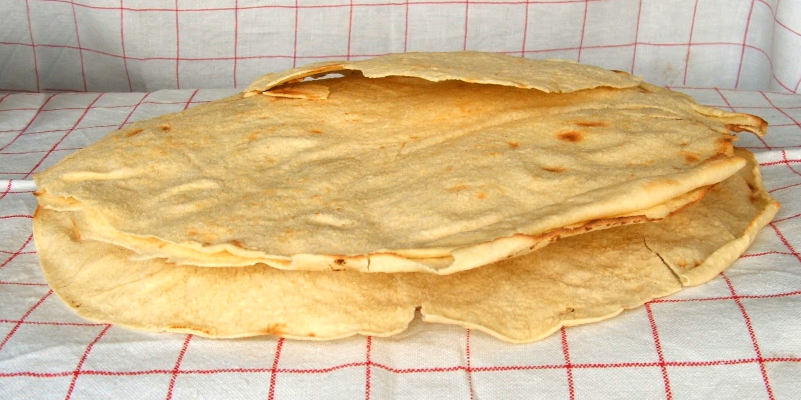 Pane carasau, thin sheets of bread on a tablecloth